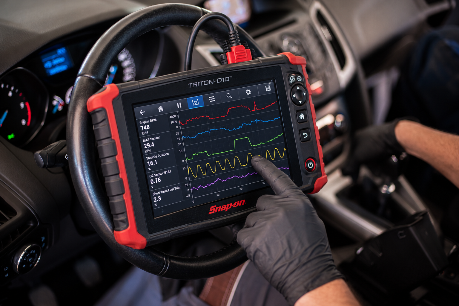 Illustration of a gloved technician using a diagnostic scan tool